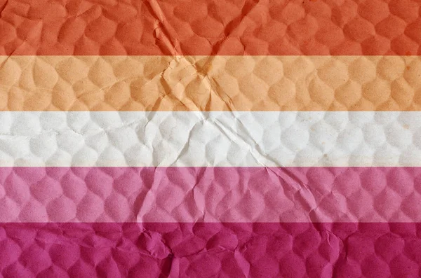 Flag of lesbian pride on an uneven textured surface. Concept of love, equality, freedom of choice, unity in diversity, beauty and joy.