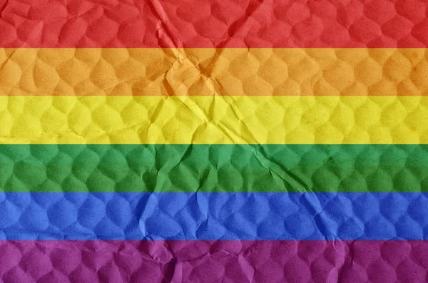 A rainbow flag on an uneven textured surface. Pride flag of the LGBT community. Concept of love, equality, freedom of choice, unity in diversity, beauty and joy.