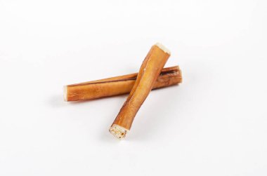 Dog Treats. Popular Natural chew treats for dogs on a white background. 6-inch Bully sticks. Dried bovine penis. Air dried Beef pizzle.