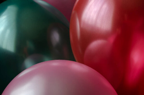 Shiny Balloons close-up. Red, pink and green. Holiday attribute. Selective focus.