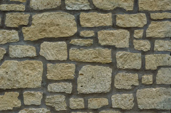Sarı Duvar Rastgele Şekil Boyutlarda Düz Olmayan Taşlardan Yapılmıştır Mimari — Stok fotoğraf