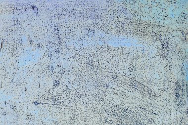 Mavi boyanmış metal duvardaki noktalar ve pas lekeleri. Şişmiş kabuk soyulmuş çatlak boya. Aşınmış metal arkaplan.