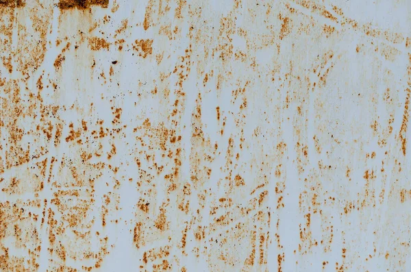 Rust stains. Rusted painted metal wall. Rusty metal background with streaks of rust. Corroded metal background.