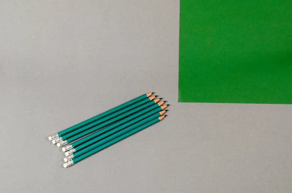 Wooden Pencils Green Piece Paper Gray Background Set Pencils Quadratic — Stock fotografie