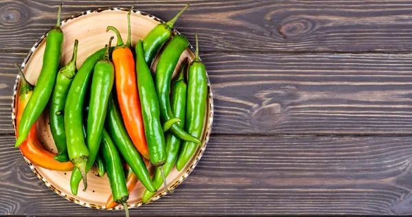 Spicy Mexican peppers on a platter. Spanish tapas on wooden vintage background. Flat top view with copy space, food still life concept — Stock Image Spicy Mexican Peppers Platter Spanish Tapas Wooden Vintage Background Flat Royalty Free Stock Photos