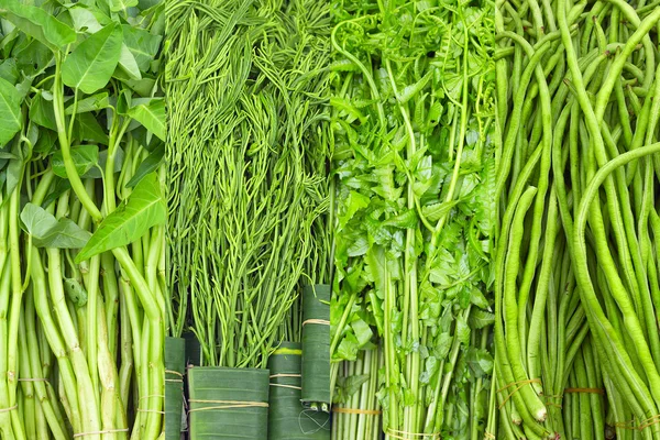 Fresh Thai greens: water spinach, cha om, fern, green beans