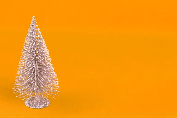 Kleine Glimmende Kerstboom Een Gele Achtergrond Kopieerruimte — Stockfoto