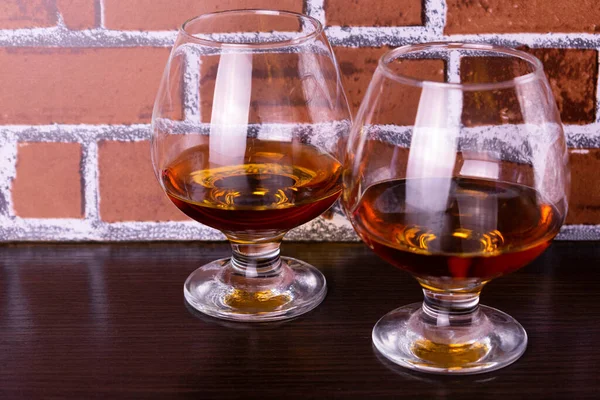 Two Glasses Cognac Brick Wall Background — Stock Photo, Image