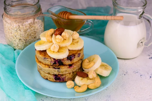 Oatmeal pancakes with banana and honey. Healthy breakfast concept.