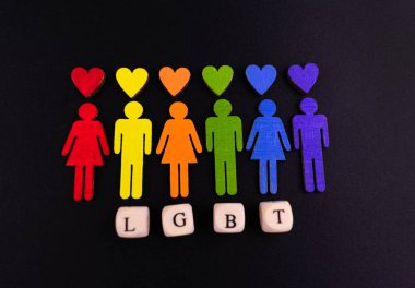Baner of the LGBT community. Little men in the colors of the flag of the LGBT community on a black background. Minority sex equality concept.