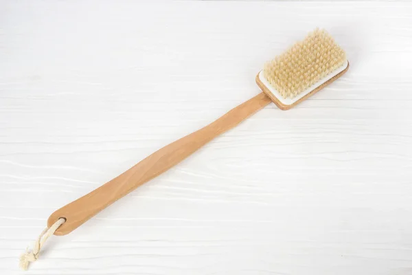 Bath brush on white wooden background — Stock Photo, Image