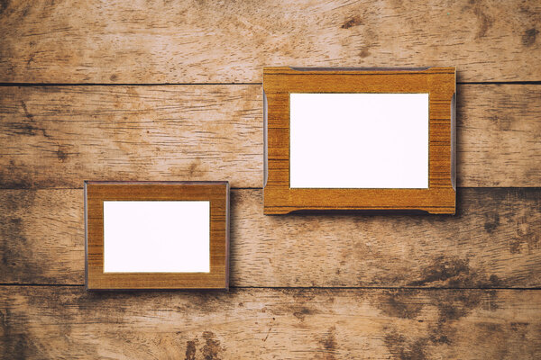 Blank photo wood frame on wooden wall