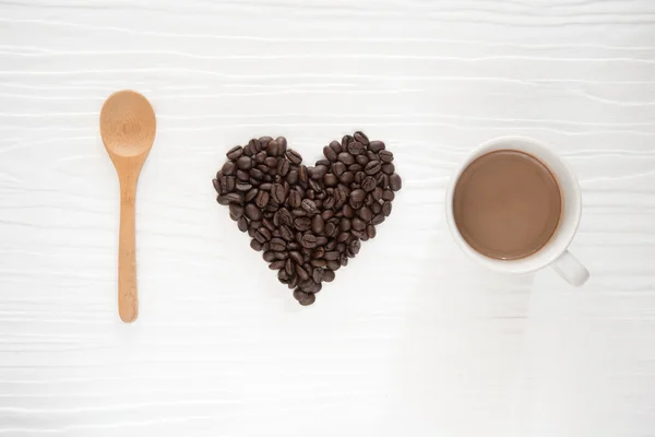 I love coffee, coffee beans and mug on wood background