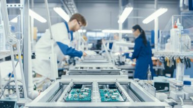 Shot of an Electronics Factory Workers Assembling Circuit Boards by Hand While it Stands on the Assembly Line. High Tech Factory Facility. clipart