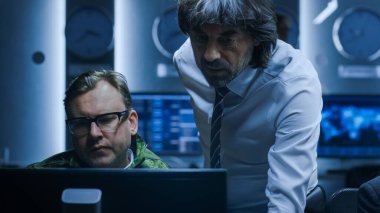 Bilgisayar 'da çalışan Siber Güvenlik Danışmanı Askeri Subayı. Sistem Kontrol Odasında Bilgisayarlar Üzerinde Çalışan Uzmanlar.