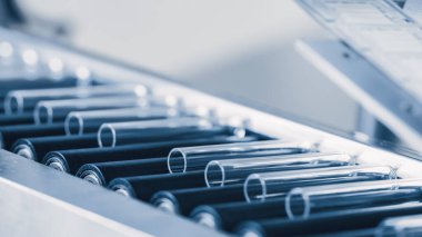 Endüstriyel Üretim Tıbbi Test Tüplerinin Endüstriyel Dönüştürücü 'ye yakın plan çekimi. Steril Yüksek Hassas Fabrika Makinesi Tıbbi Kullanım Malzemeleri Üretiyor. Soyut Endüstri