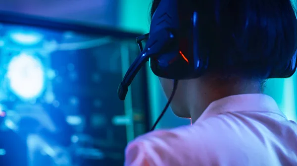 Close-up Portrait Shot of the Professional East Asian Gamer Playing in Online Video Game on His Personal Computer. Talking into Microphone. Room Lit by Neon Lights in Retro Arcade Style. Cyber Sport — Stock Photo, Image