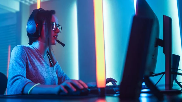 Low Angle Shot of the Beautiful Friendly Pro Gamer Girl Playing in Online Video Game and Streaming it, Wearing Headset Talks with Her Fans and Team into Headphones Microphone. Teenagers Having Fun — Stock Photo, Image