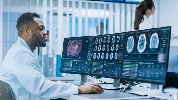 Medical Scientist Werken met CT Brain Scan Afbeeldingen op een Personal Computer in Laboratory. Neurologen in Neurologisch Onderzoekscentrum Werken aan een Hersentumor Cure. — Stockfoto