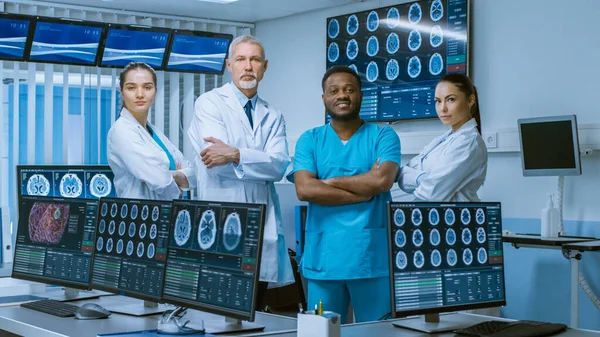 Diverse Team of Medical Scientist Posing with Crossed Arms in the High-Tech Laboratory Brain Sceince Neurology Center Research Lab with Multiple Dispalys Showing CT MRI Scan Images. — стокове фото