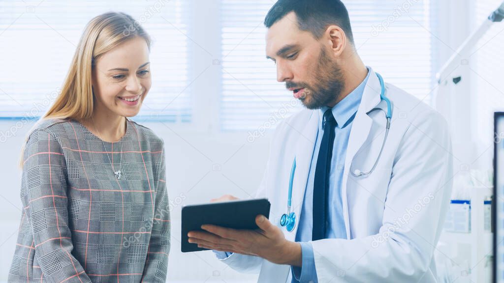 Beautiful Female Visits Doctors Office, He Shows Tablet Computer with Her Medical History They Discuss Her Health and Other Medical Issues. Modern Medical Office.