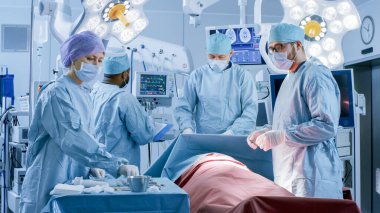 Diverse Team of Professional Surgeons Performing Invasive Surgery on a Patient in the Hospital Operating Room. Nurse Pick Up Instruments, Anesthesiologist Monitors Vitals. Real Modern Hospital. clipart