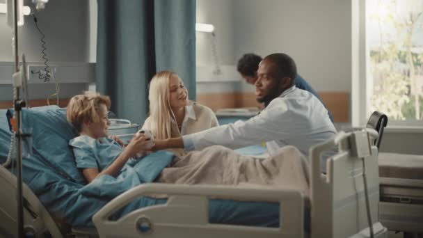 Sairaala Ward nuori poika sängyssä äiti vierailee lääkäri Consulting — kuvapankkivideo