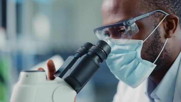 ( 영어 ) Close Up Black Male Scientist - Face Mask Using Microscope in Laboratory — 비디오