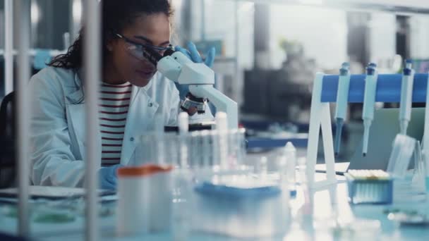 Ung kvinnlig forskare som arbetar i laboratorium — Stockvideo