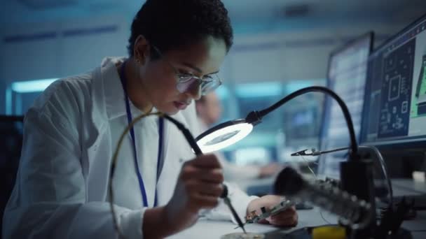 Electronics Development Facility Female Scientist Soldering Motherboard — Stock Video