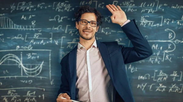 Online e-Education Concept: Teacher Greets Class, Εξηγεί το Μάθημα στην τάξη, Behind Him Blackboard with Writing. e-Learning, Online Μαθήματα: Lecturer does Video Call, Εξηγεί Θέματα στους Φοιτητές Φωτογραφία Αρχείου