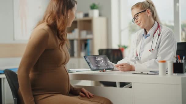 Lékař ukazuje tablety s ultrazvukovým vyšetřením těhotným pacientkám — Stock video
