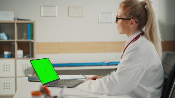 Doctor in Office Answering Video Call with Green Screen — Stock Video