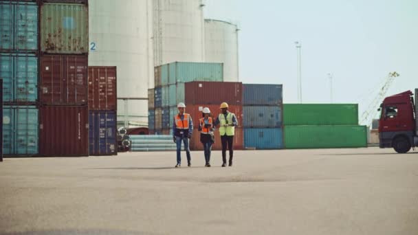 Ingenieros industriales caminan en la terminal de contenedores — Vídeo de stock