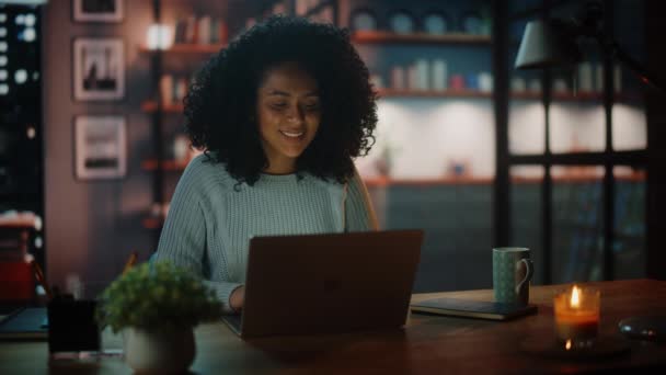 Lateinamerikanerin arbeitet abends am Laptop im dunklen Wohnzimmer — Stockvideo