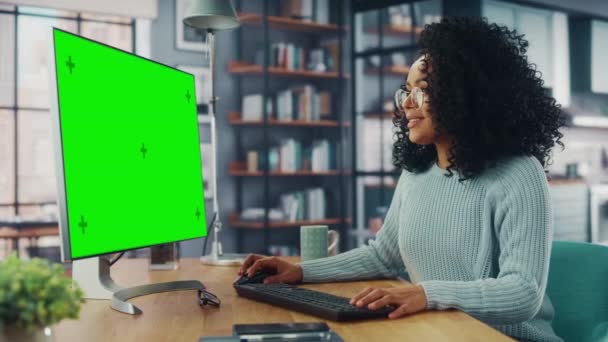 Female Using Computer with Green Screen in Living Room — Stock Video