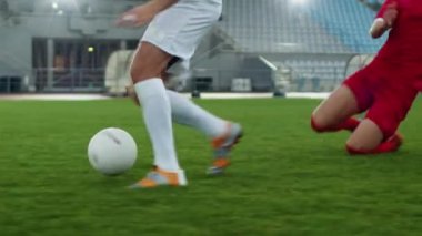 Focus on Legs Football Player Leads and Dribbles Ball Around Rival Players