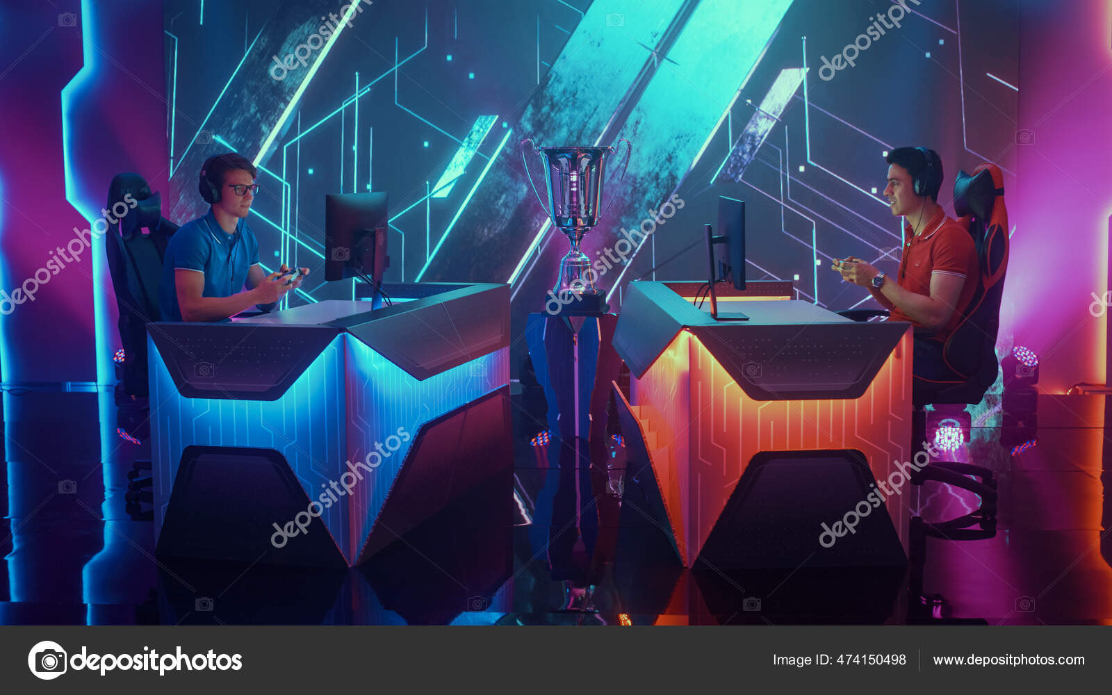 Two Professional Esport Gamers Using Controllers Playing Console Video Games on a Championship Event with Big TV Screens and Stylish Neon Arena