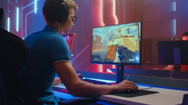 Professional eSports Gamer Plays Mock-up 3D First Person Shooter Video Game His Personal Computer. Cyber Gaming Tournament Championship. Medium Shot clipart