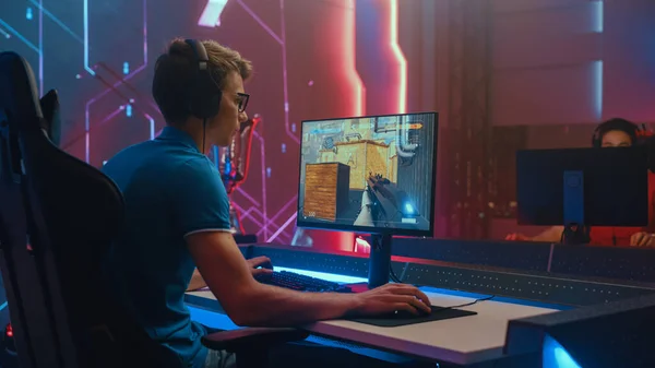 Professional eSports Gamer Plays Mock-up 3D First Person Shooter Video Game His Personal Computer. Cyber Gaming Tournament Championship. Back View Shot — Stockfoto