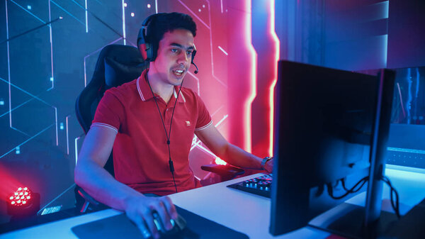 Professional eSports Gamer Playing in Computer Video Games. In Background Stylish Graphics. Online Cyber Championship Tournament. Portrait Semi-Side View