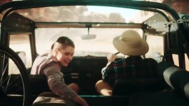 Travelers Riding in Car Desert
