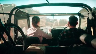 Travelers Riding in Car Desert
