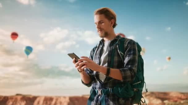 Joven turista masculino usando Smartphone en Canyon — Vídeos de Stock