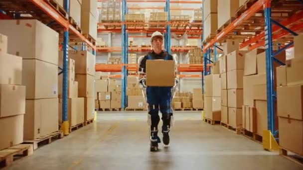 Lavoratore moderno futuristico del magazzino con la scatola di cartone dei movimenti del vestito dell'esoscheletro — Video Stock