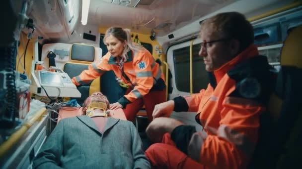 Paramedics Providing Medical Help to Patient in Ambulance — Stock Video