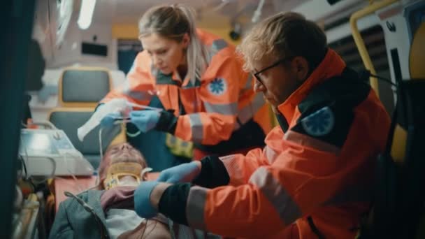 Paramedics Providing Medical Help to Patient in Ambulance — Stock Video