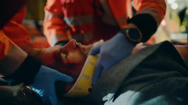 Paramedics Provide Medical Help to Young Man Lying on a Street — Stock Video