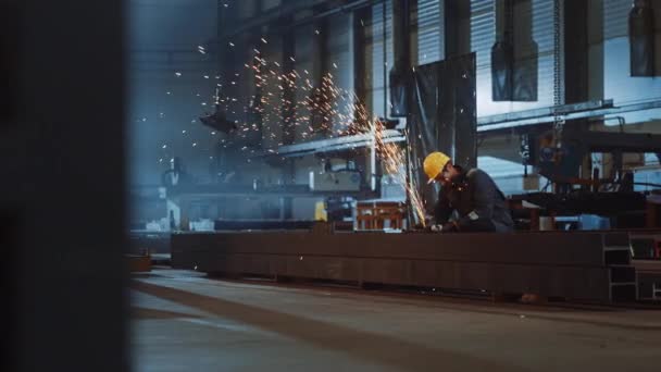 Worker Works with Angle Grinder in Industrial Steel Factory — Stock Video