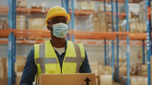 Big Warehouse Handsome Man Wearing Face Mask walking with Box — Stock Video